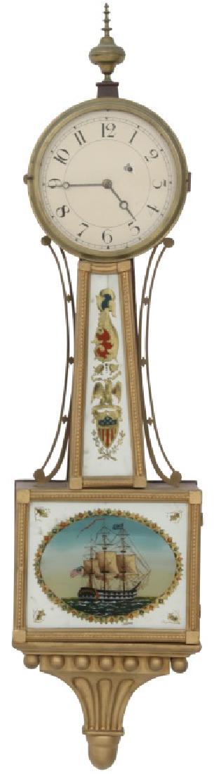 Weight Driven Unsigned Banjo Clock: Weight Driven Unsigned Banjo Clock. With painted dial in a presentation gilded case with brass finial on top. The gilding case has been redone. Dimensions: 10 in. wide x 41 in. high x 4 in. deep. Weig