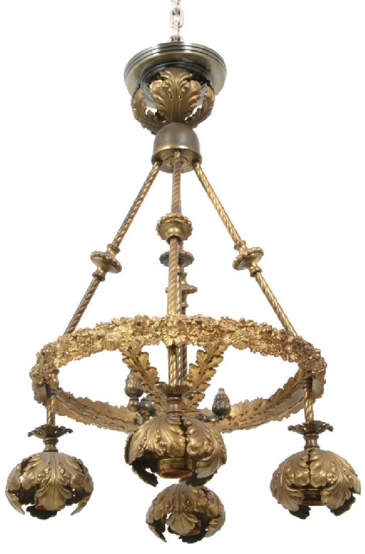 Bronze Gas & Electric Chandelier: Bronze Gas & Electric Chandelier. Has 4 splayed spiral turned arms supporting the floral relief decorated lower ring and 1 central pendant arm with double burner gas fixture below; the lower ring has 