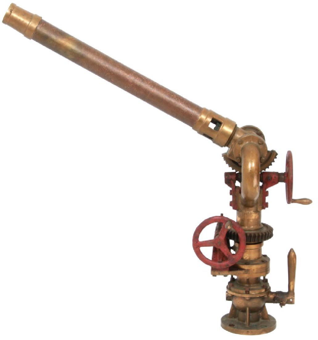 Brass and Iron Ship's Water Cannon: Brass and Iron Ship's Water Cannon. A heavy duty, solid brass water cannon, having a pedestal with turning mechanism, valves and 2 valve wheels. Dimensions: 40 in. wide x 26 in. high x 14 in. deep. We
