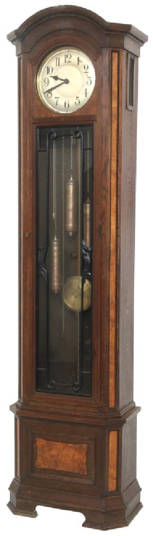 Oak and Figured Maple 3 Weight Grandfather Clock: Oak and Walnut 3 Weight Grandfather Clock. The metal dial has black numerals, three brass covered weights and a brass covered pendulum bob with wooden stick. The door has ebonized wood carvings over t