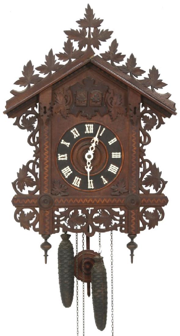 Lot of Two Black Forest Cuckoo Clocks: Lot of Two Black Forest Cuckoo Clocks. 1. Inlaid case with pierced carvings of leaves, Pierced brass weight driven movement with carved pendulum, 2 pinecone weights and half hour strike; strike mechan