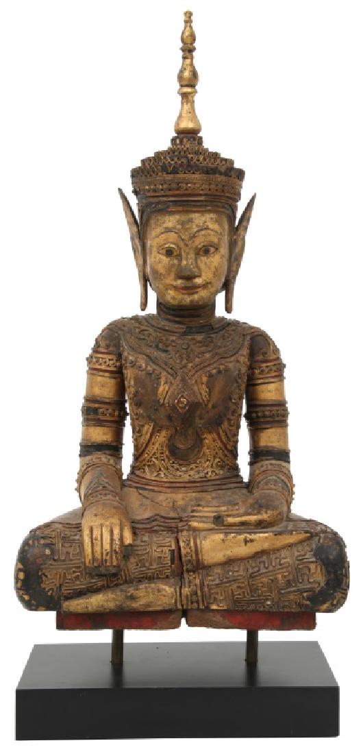 Gilt Carved Seated Buddha Sculpture: Gilt Carved Seated Buddha Sculpture. Seated figure of a crowned Buddha with applied garment highlights and on a contemporary stand. Has loss to the applied highlights. Dimensions: 29 in. high x 12.5 i