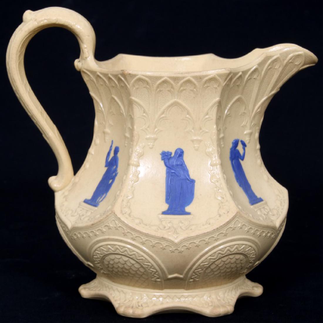 English Gothic Style Signed Wedgewood Pitcher: English Gothic Style Signed Wedgewood Pitcher. English Gothic style signed Wedgewood salt glaze pottery pitcher with incised signature on the bottom, having blue raised classical figure applications i