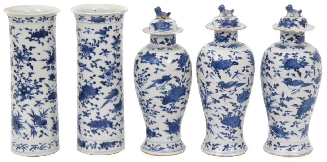 Chinese Blue & White Porcelain Garniture Sets: 5 Pieces Chinese Blue & White Porcelain Garniture Sets. 2 cylindrical form 10.25 in. vases and 3 baluster form covered urns with foo dog finials, 10.75 in. high; decorated with birds and filigree. Qin
