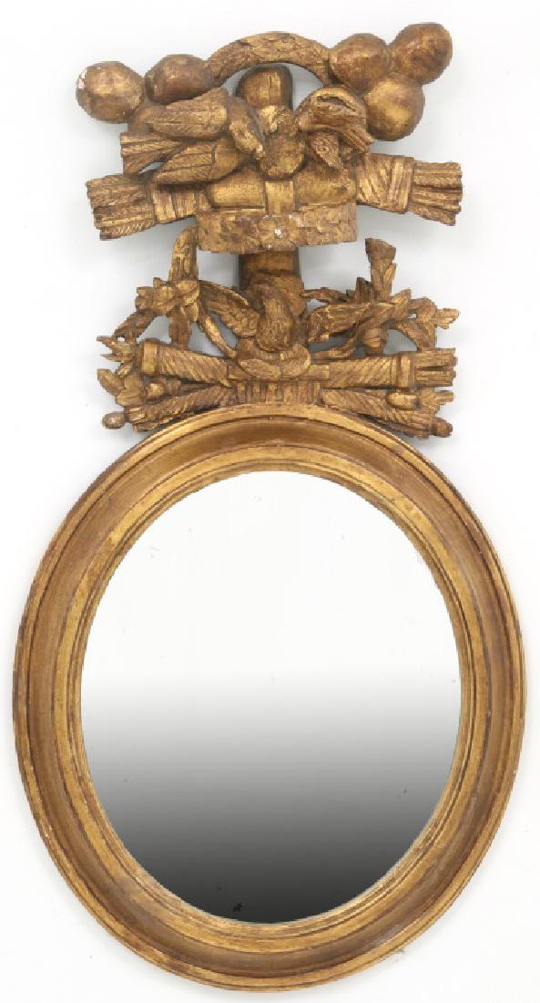 Oval Gilt Carved Wall Mirror w/ Birds: Oval Gilt Carved Wall Mirror w/ Birds. Crest is a carving of an eagle with spread wings over a shield with crossed torches and garland, bowed floral wreath above and 2 more birds over crossed arrow qu