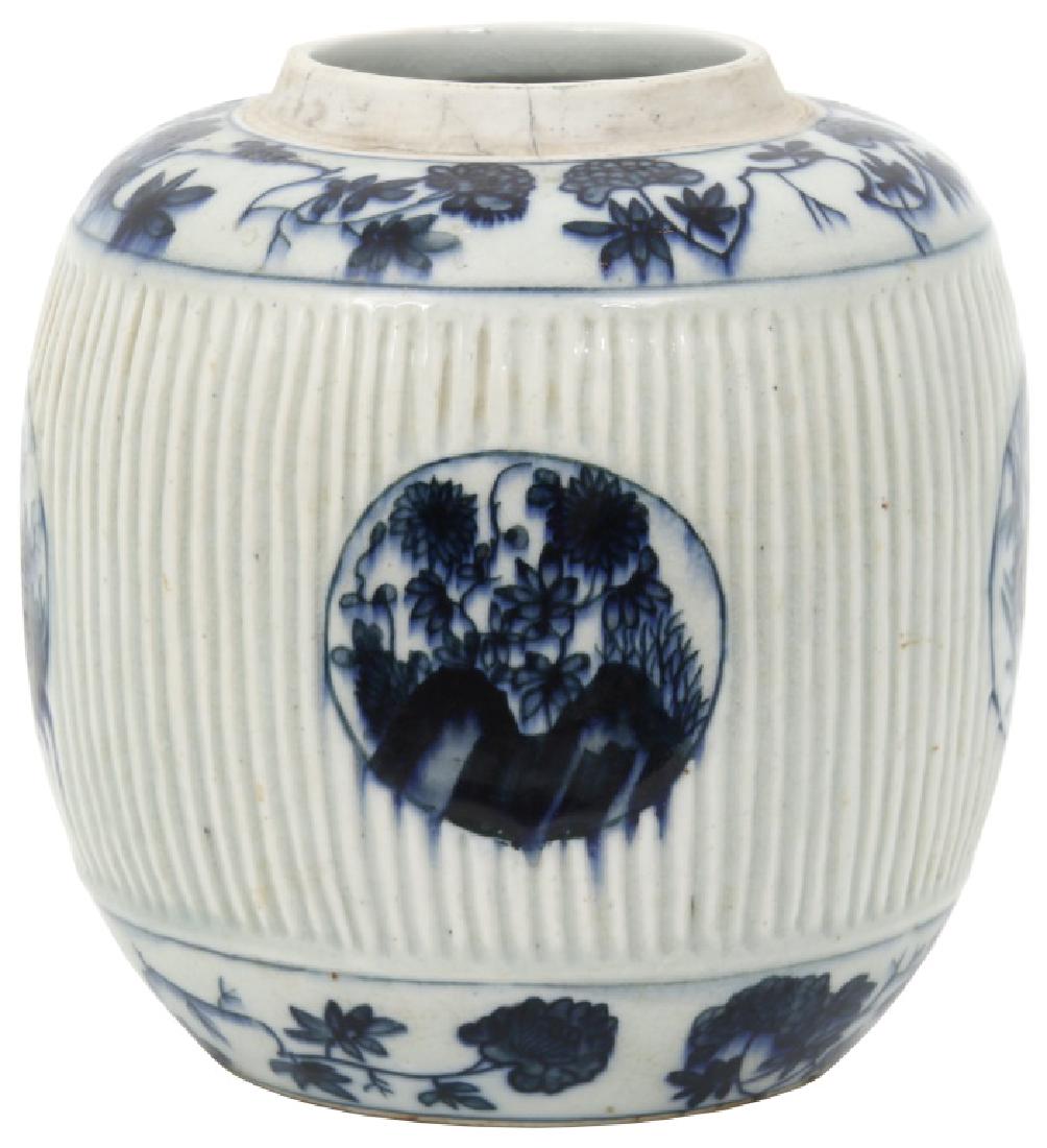Chinese Kangxi Style Ribbed Ginger Jar: Chinese Kangxi Style Ribbed Ginger Jar. 8 in. high x ribbed form jar with blue and white flower and filigree borders and 4 blue and white round panels; signed with Kangxi style mark; small hairline in