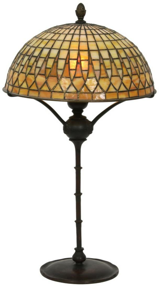 Tiffany Studios Geometric Table Lamp: Tiffany Studios Geometric Table Lamp. 12 1/4 inch diameter domical shade has a graduated geometric pattern with repeating spires, signed "Tiffany Studios, New York." The shade has one small panel with