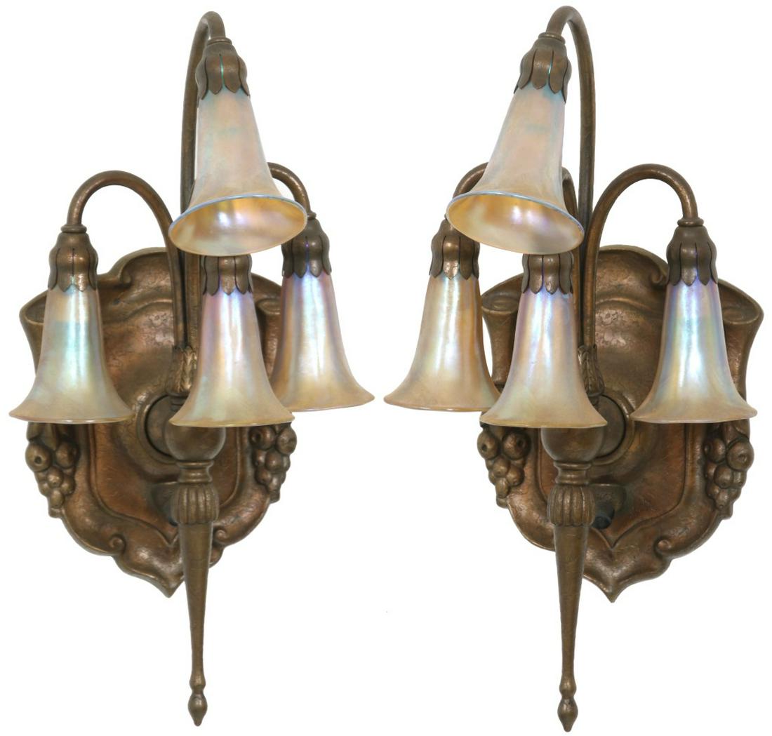 Pair of Tiffany Studios 4 Light Lily Sconces: Pair of Tiffany Studios 4 Light Lily Sconces. Tiffany sconces in gold dore finish with four iridescent lily shades having a ribbed and trumpeted form are held aloft by four curved, graceful arms which