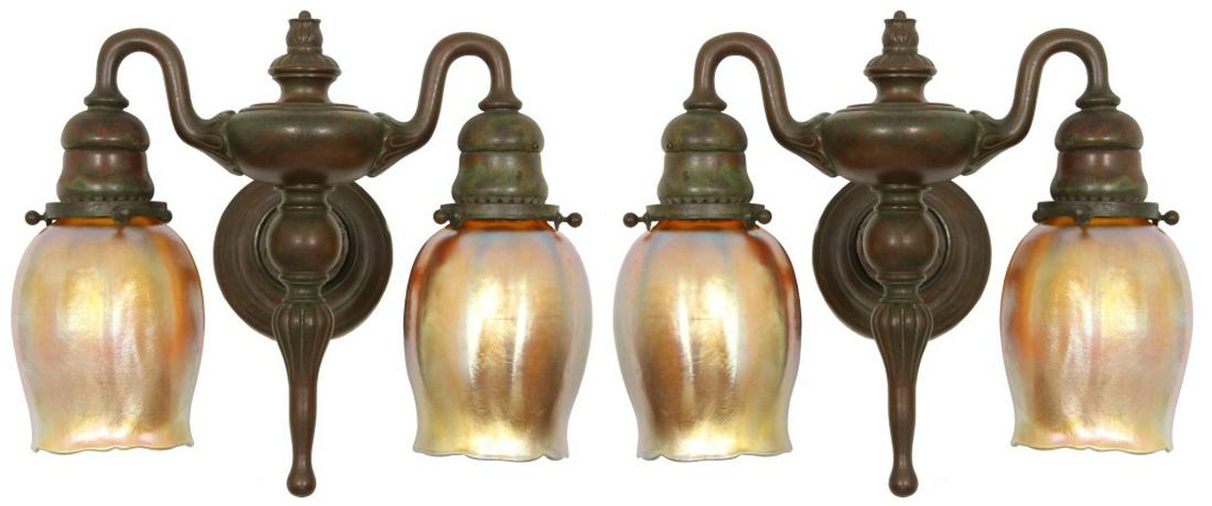 Pair of Tiffany Studios Bronze Sconces: Pair of Tiffany Studios Bronze Sconces. Pair of two-armed bronze sconces with artichoke pattern in a good original green-brown patina, have original Geco turn switches. The 4 matching gold iridescent 