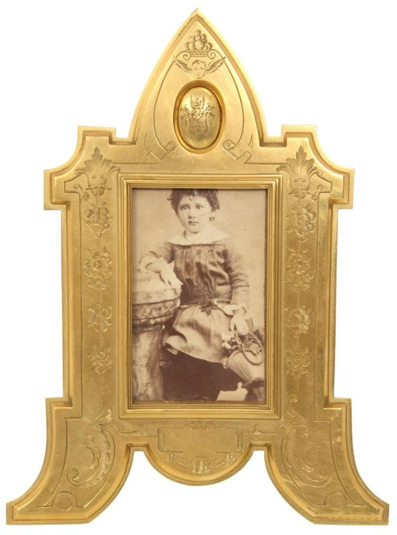 Tiffany & Co. Dore Bronze Picture Frame: Tiffany & Co. Dore Bronze Picture Frame. Frame has intricate designs of mythical faces, grape clusters, flowers, scrolling, and a coat of arms. Signed "Tiffany & Co., Union Square." on the easel. Miss