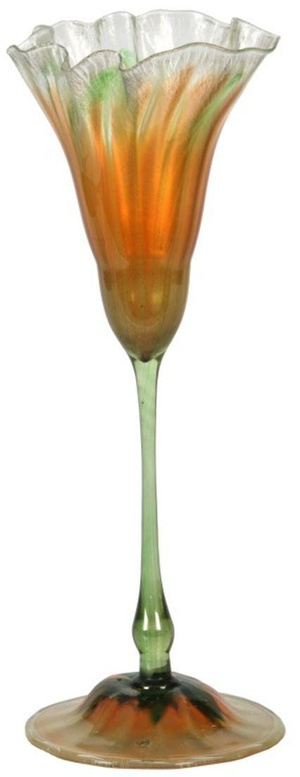 Tiffany Studios Favrile Glass Floriform Vase: Tiffany Studios Favrile Glass Floriform Vase. Favrile glass vase has a bulbous foot applied to a long, thin stem which has hints of a green pulled feather design, tapers up through the top which has a