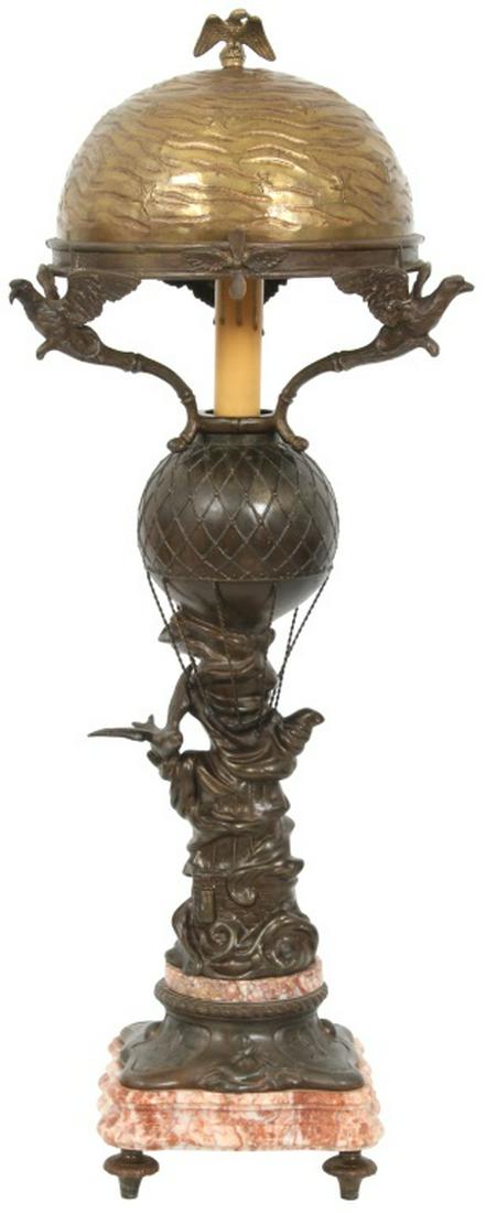 Bronze Hot Air Balloon Lamp: Bronze Hot Air Balloon Lamp. The base depicts a hot air balloon with a bird on the side in flight, has a two section striated marble and bronze base and stands on 4 turned feet. The 3 arms depicting e