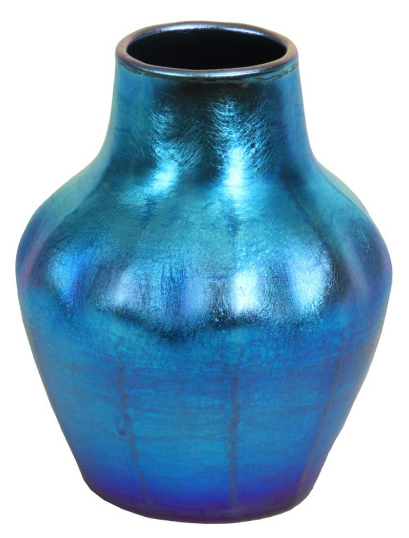Tiffany Studios Favrile Glass Vase: Tiffany Studios Favrile Glass Vase. The blue iridescent favrile glass vase has a ribbed, ovoid form body and iridescent violet highlights at the bottom; signed on the underside, "L. C. Tiffany - Favri