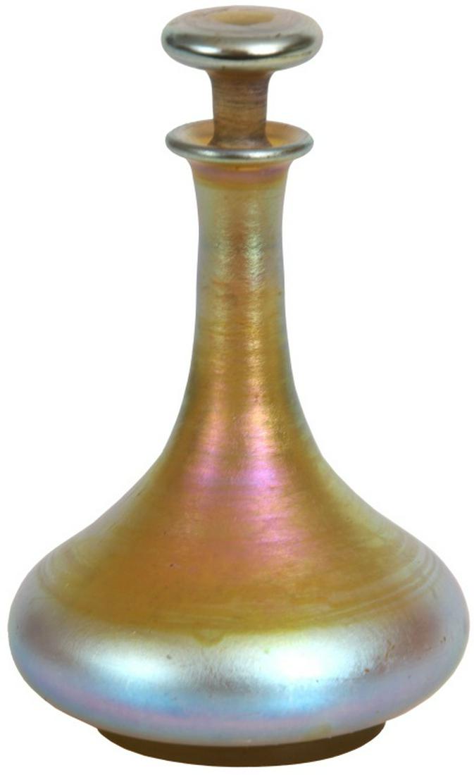 Tiffany Studios Favrile Glass Perfume: Tiffany Studios Favrile Glass Perfume. Tiffany perfume with gold iridescence has a low, bulbous body with long tapering neck, flaring rim and is complete with the original stopper; signed on the under