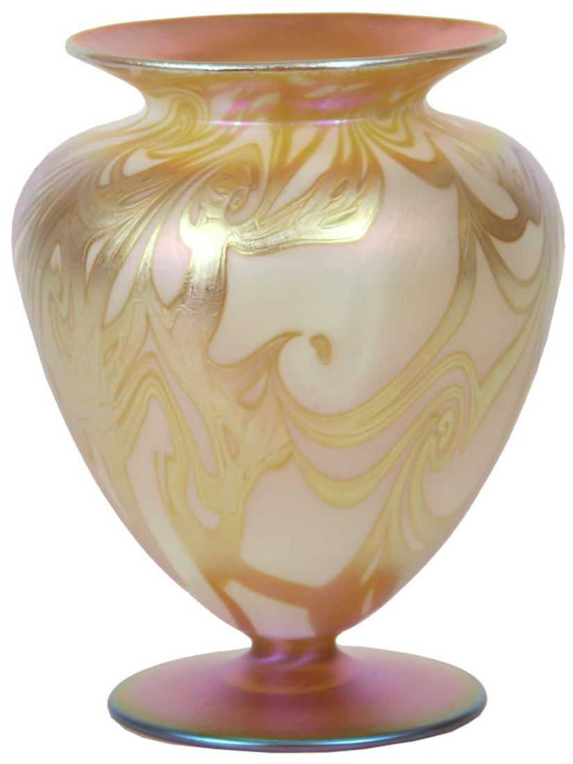 Quezal Gold Iridescent Coil Vase: Quezal Gold Iridescent Coil Vase. The flaring rim has a gold iridescent interior, tapering down to an urn form shaped body with designs of gold iridescent coils, standing on a deep purple iridescent b