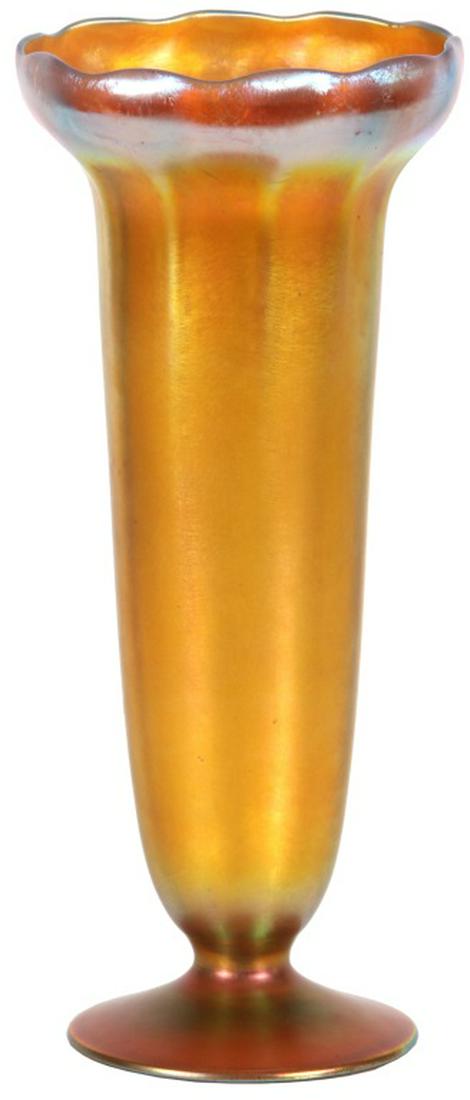 Tiffany Studios Favrile Glass Vase: Tiffany Studios Favrile Glass Vase. Gold iridescent footed vase has a long ribbed body with a flared and turned in ruffled rim; signed on the underside, "L. C. Tiffany - Inc - Favrile 1549 - 4731N." I