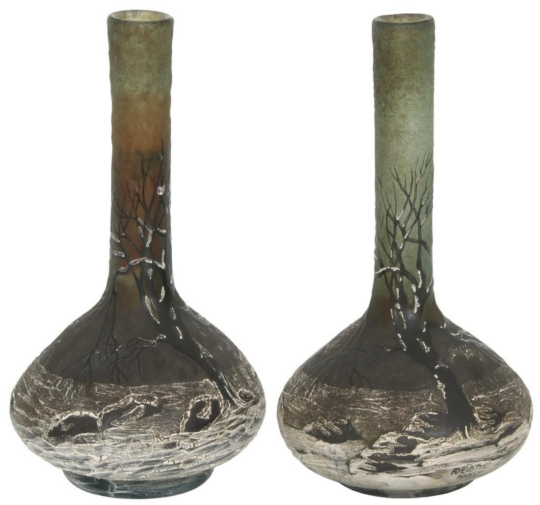 Signed Delatte Nancy Cameo Glass Vases: Signed Delatte Nancy Cameo Glass Vases. Pair of cameo glass and enamel vases depicting a winter scene with trees covered in snow, having bulbous bases and long necks; signed "ADelatte Nancy." on the b