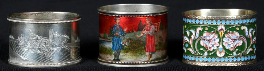 Lot of 3 Russian Napkin Rings: Lot of 3 Russian Napkin Rings. 1). Gilt and colorful enameled napkin ring with by Gustav Klingert. 2). Laqure painted napkin ring depicting a scene of a man and woman with a red sunset background, sig