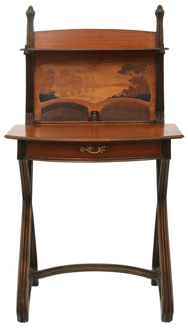 Attr. Louis Majorelle Inlaid French Desk: Attr. Louis Majorelle (French, 1859-1926), Writing Desk. Art Nouveau mahogany and marquetry inlaid writing desk has a scenic back panel of a woodland lake scene, single bowed drawer with flower and le