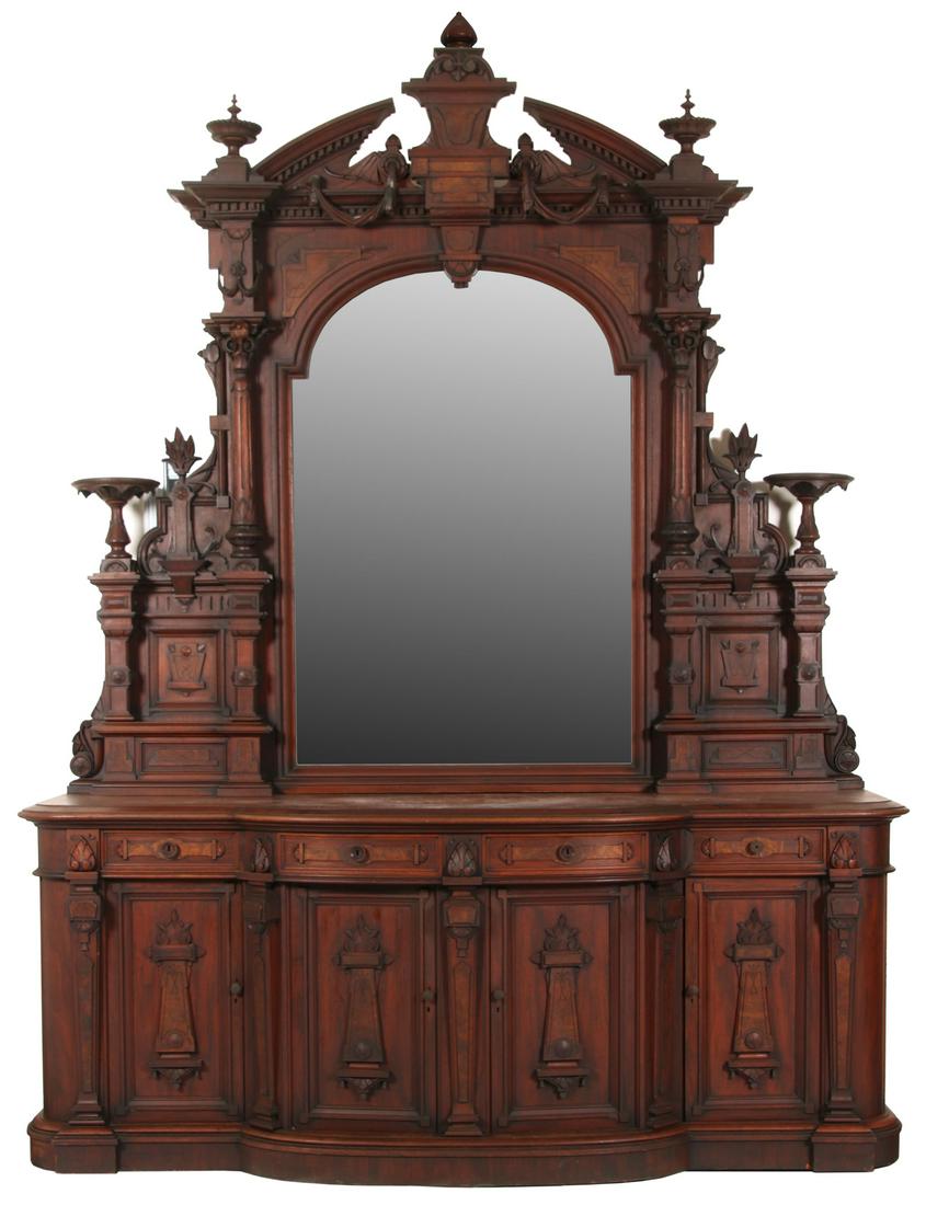 Monumental 11' Renaissance Revival Sideboard: Monumental 11' Renaissance Revival Walnut Sideboard. The top has three turned finials and a crest with dentil molding design and wood carvings depicting draping fabric; the large arched center mirror 