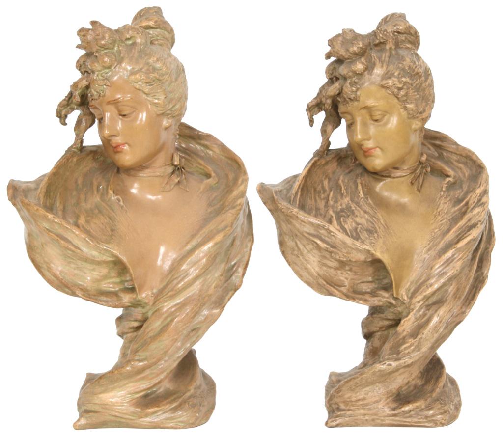 Two Amphora Busts by E. Stellmacher: Two Amphora Busts by E. Stellmacher. Terracotta busts of Art Nouveau woman wearing garments and bows around their necks; signed on the bottom “Ed. Stellmacher,” on back “RStK” and numbered “