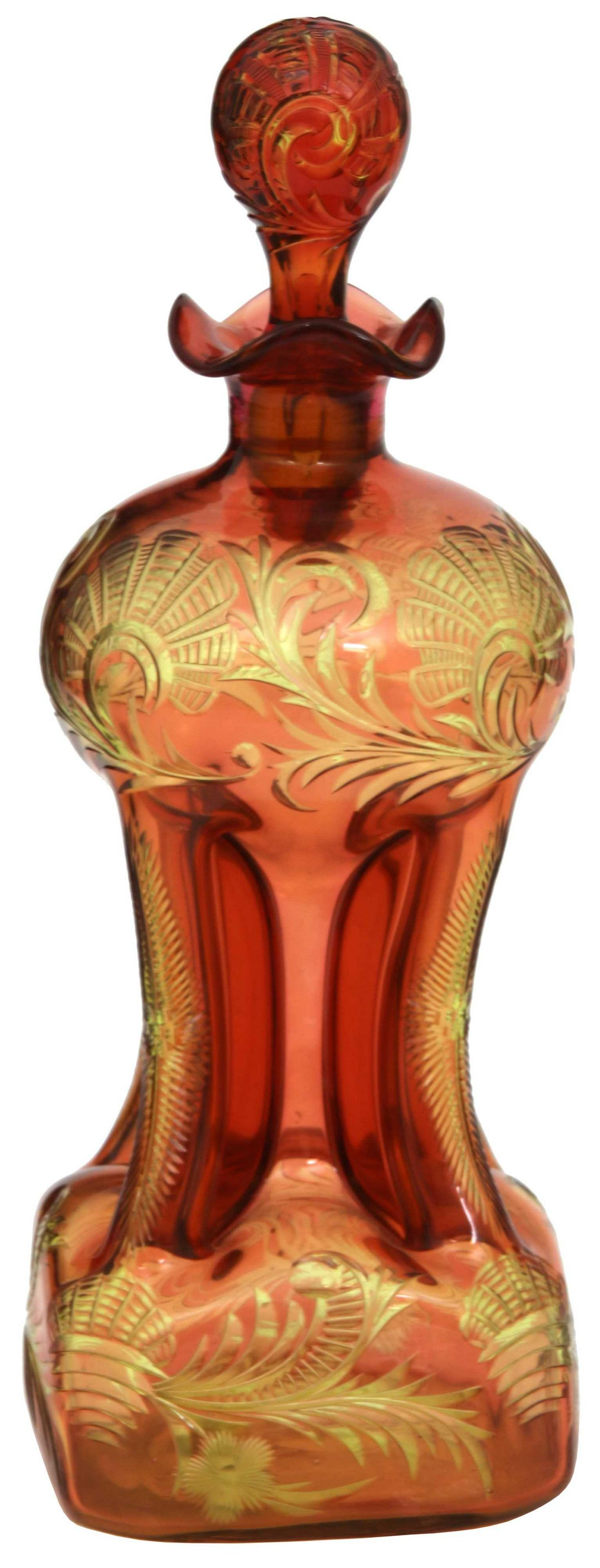 Stevens & Williams 2 Color Cut Overlay Decanter: Stevens & Williams two-color wheel cut overlay pinched decanter. Has a cranberry-pink over yellow glass surface, intricately cut with allover filigree; has a squared form with pinched body and origina