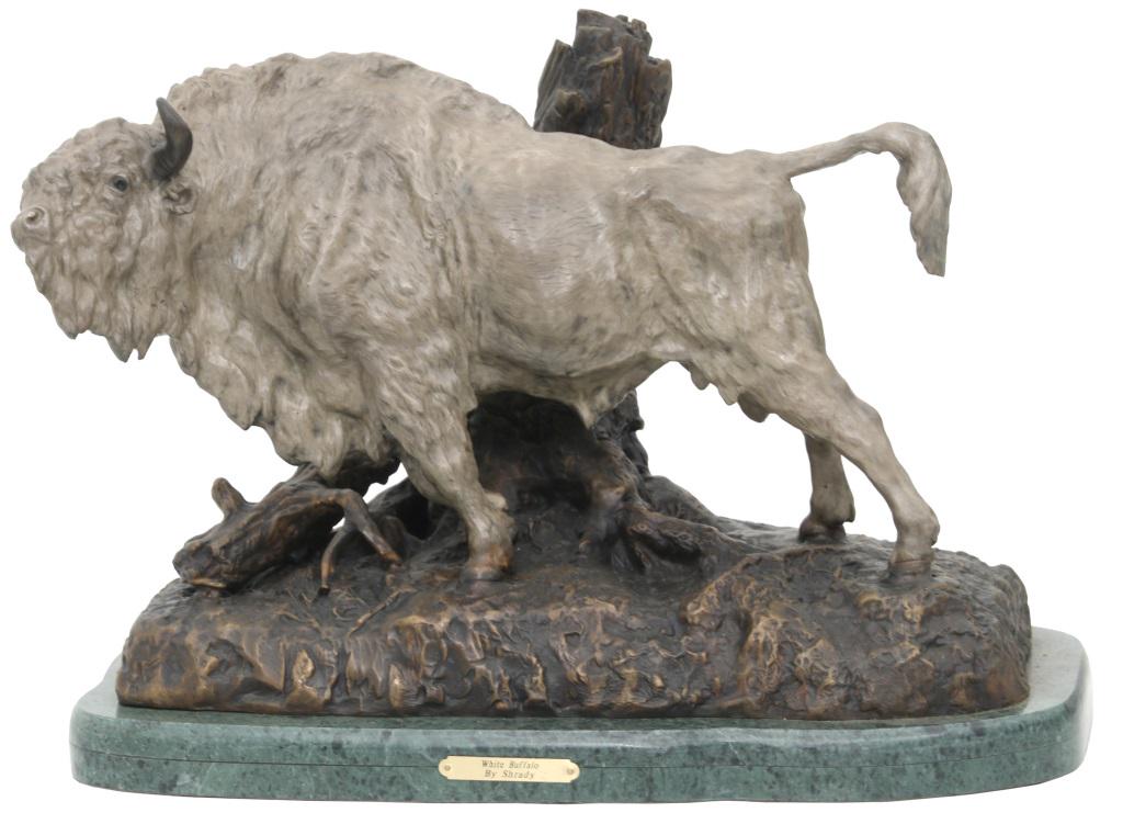 After Henry Merwin Shrady Bronze Buffalo: After Henry Merwin Shrady (American, 1871-1922), Polychromed white bronze buffalo against a tree trunk on a green marble marble base. Dimensions: 16 in. high x 13 in. wide x 22 in. long. Weight: 105 l