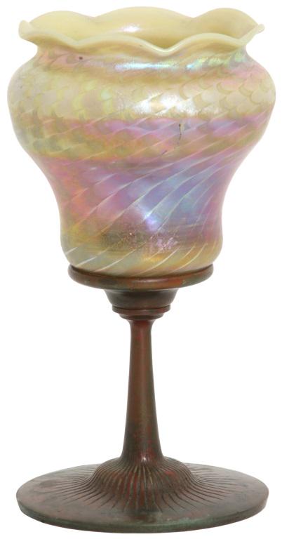 Tiffany Studios Favrile Glass Candle Lamp: Tiffany Studios Favrile Glass Candle Lamp. Signed on the underside of bronze base, "Tiffany Studios, New York"; shade is numbered "L2517." Overall good condition with a chip on the collar, mostly hidd