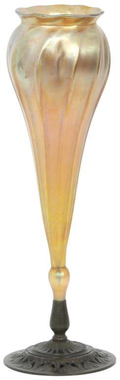 Tiffany Studios Favrile Glass Vase in Bronze Base: Tiffany Studios Favrile Glass Vase in Bronze Base. Gold Iridescent floriform vase, signed on the underside of base, "Tiffany Studios, New York." 13 1/2 in. high. Weight: 1.55 lbs.