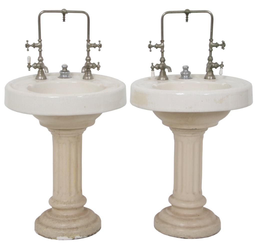 Pair of Barber Shop Pedestal Sinks: Pair of Barber Shop Pedestal Sinks. Porcelain over cast iron round bowls on reeded pedestal bases, (painted) with original nickel plated brass hardware. Dimensions: 46 in. high x 24 in. wide x 23.5 in