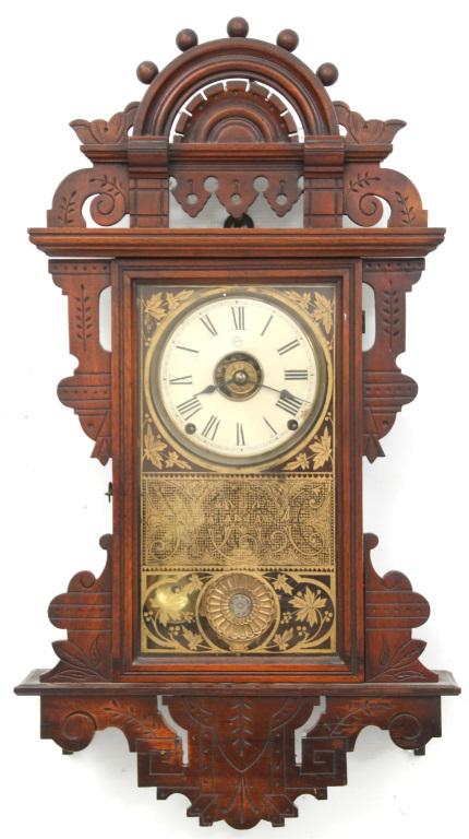 Seth Thomas Eclipse: Seth Thomas Eclipse. Ornate wall hanging walnut case in original finish. 5.5 inch dial with brass 8 day time, strike & alarm movement. Clock is running, bell strike functions, alarm needs adjustment.