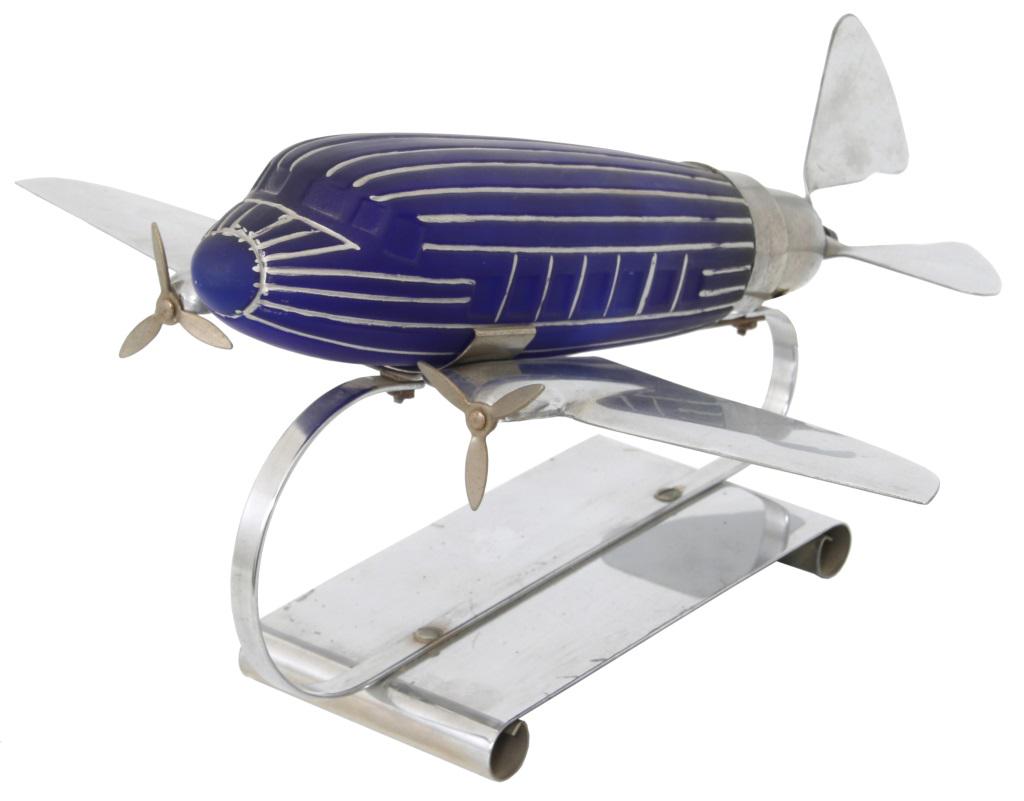 Art Deco Vintage Blue Airplane Lamp: Art Deco Vintage Blue Airplane Lamp. Cobalt blue glass body with original painted silver lines mounted in a chromed metal frame, modeled after the Douglas DC-3 aircraft. In very good condition with no