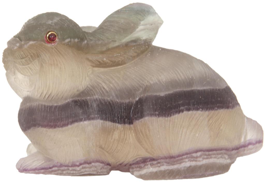 Russian Carved Stone Rabbit in Case: Russian Carved Stone Rabbit in Case. The miniature rabbit is carved out of stone and has gold and ruby eyes. Dimensions: 3 in. long. Weight: 7.28 oz.
