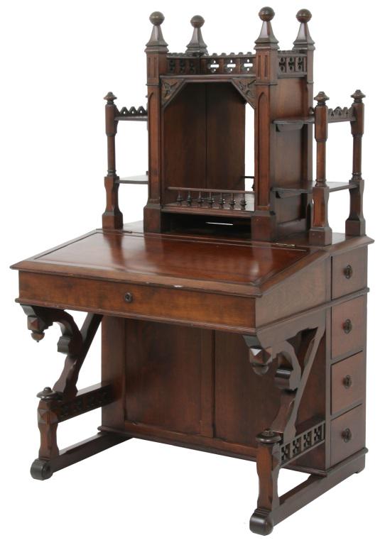 American Gothic Revival Walnut Davenport Desk: American Gothic Revival Walnut Davenport Desk. Top has a carved gallery with tall spires & ball-top corner finials, two shelves on either side of a mirrored center, the slanted writing surface is hing