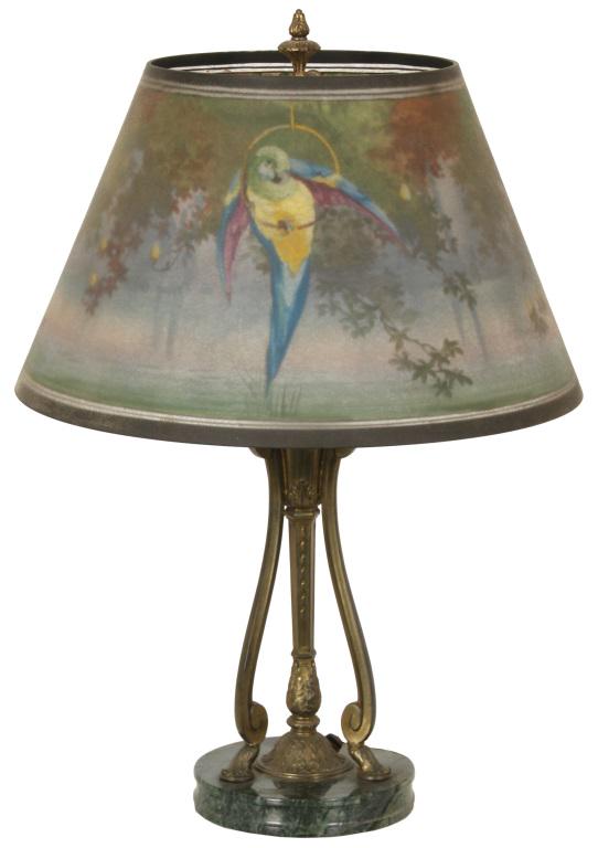 Pairpoint "Seville" Parrot Lamp: Pairpoint "Seville" shade with a colorful parrot in the foreground against a foliate forest background scene. On a signed Pairpoint onyx & metal base. Dimensions: 22.5 in. high x 16 in. diameter. Weig