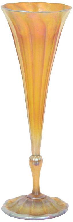 Tiffany Studios Favrile Glass Trumpet Vase: Tiffany Studios Favrile vase has an inverted saucer foot with a slender stem leading to a lightly ribbed body that is in a trumpeted form with a scalloped rim; signed on the underside, "9470 M L.C. Ti