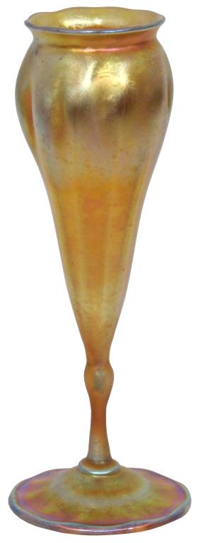 Tiffany Studios Favrile Glass Floriform Vase: Tiffany Studios Favrile glass floriform vase has a gold iridescent surface in a flowering form with long ribs that rise to the slightly ruffled and flared rim; signed on the underside, "L. C. Tiffany 