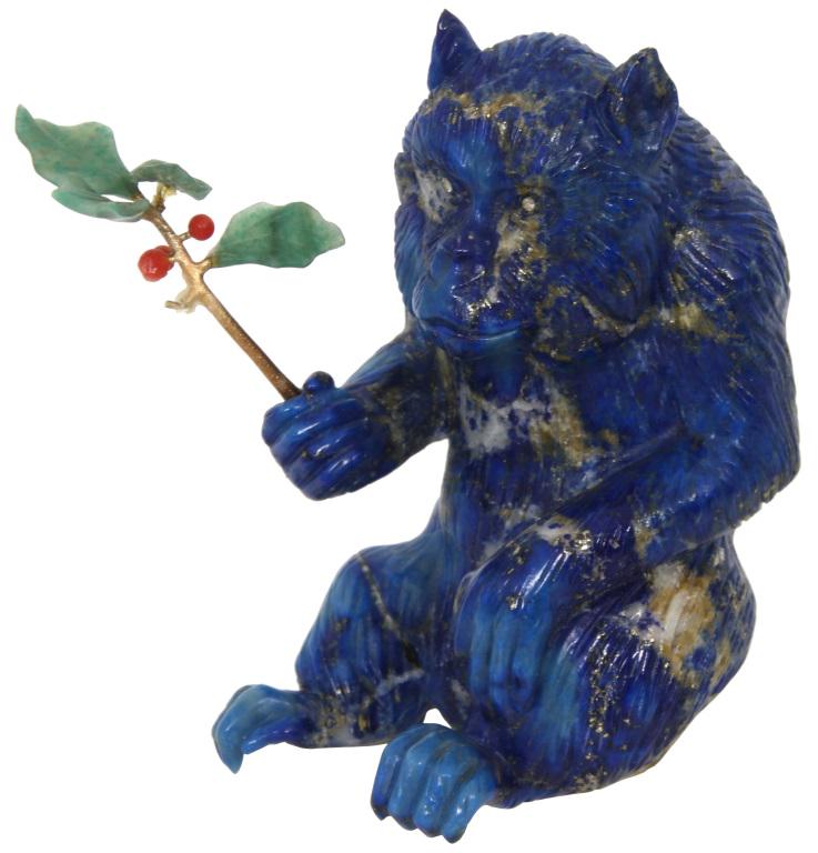 Russian Carved Lapis Lazuli Monkey: The miniature monkey is carved out of lapis lazuli and has diamond eyes. He is in a seated position holding a 14k gold branch with green jade leaves and red jade berries; marked on the underside "CW" 