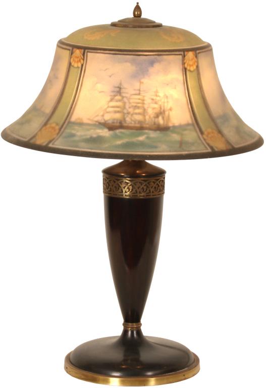 Pairpoint "Exeter" Nautical Table Lamp: Pairpoint "Exeter" shade has four panels with sailing ships, choppy seas and seagulls. Each scenic panel is framed with ribs having shell motif in between. Signed Pairpoint base and shade. Dimensions: