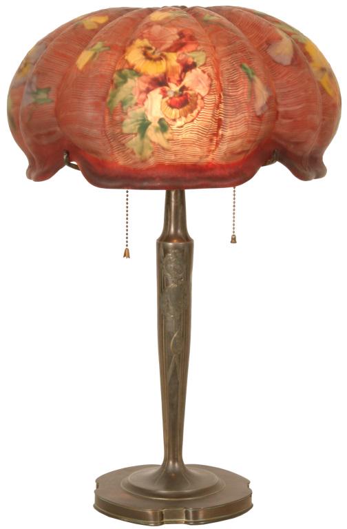 Pairpoint "Venice" Floral Table Lamp: Pairpoint "Venice" molded shade with a reverse painted floral design against a wavy stylized red background, on an Art Nouveau style signed Pairpoint base. Dimensions: 22 in. high x 14.5 in. diameter.