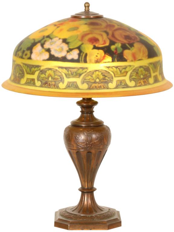 Pairpoint "Berkeley" Floral Table Lamp: Pairpoint "Berkeley" shade with a reverse painted floral design of roses & poppies against a black background. On a signed Pairpoint base with serpent motif. Dimensions: 23 in. high x 18 in. diameter.