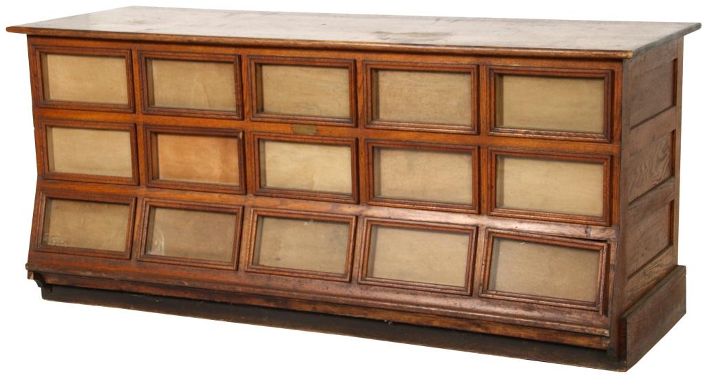 Shearer Country Store Oak Seed Counter: Nice size oak seed counter with 15 display windows & 15 adjoining storage drawers behind. Brass plaque reads: " The Shearer Counter", 1908. Dimensions: 34 in. high x 76 in. wide x 26.5 in. deep.