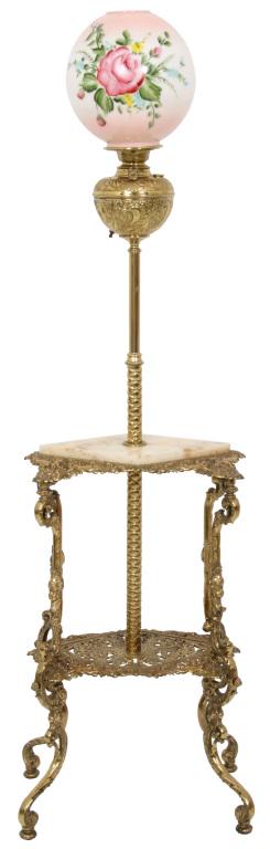 Onyx and Brass Standing Piano Lamp: Standing piano lamp has relief designs of filigree and cherubs with an inset diamond shaped onyx top. The opal glass shade has an obverse painted decoration of colorful flowers and green leaves. Dimen