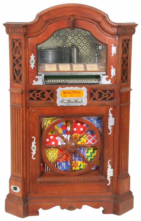 Wurlitzer Model 780-E Jukebox: Wurlitzer model 780-E jukebox, also known as the Wagon Wheel jukebox, has a mahogany case with butterfly jointed construction on the sides, large wagon wheel grill in the door covering the speaker, ch