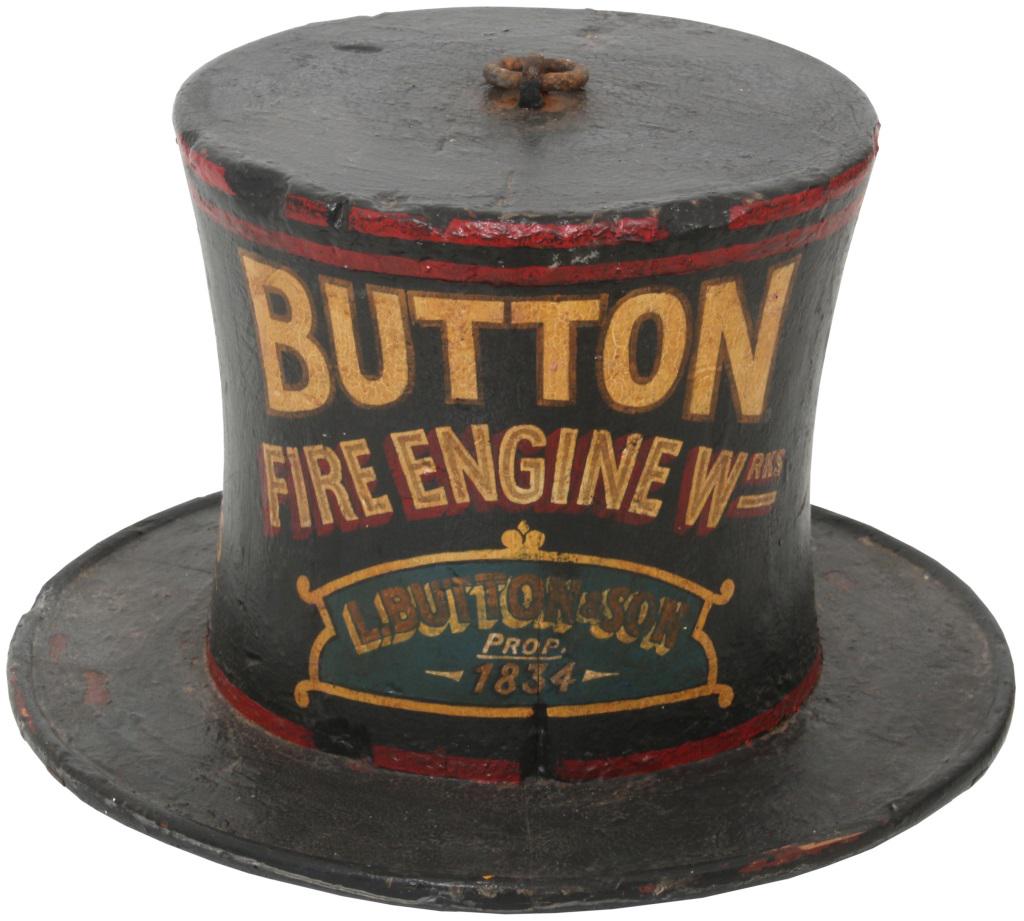 L. Button & Son Fire Engine Co. Hat Sign: L. Button & Son Fire Engine Co. advertising sign in the form of a 19th Century Fireman's hat. Has red highlights and gold lettering that reads: "Button Fire Engine Wrks, L. Button & Son, Prop. 1834." 
