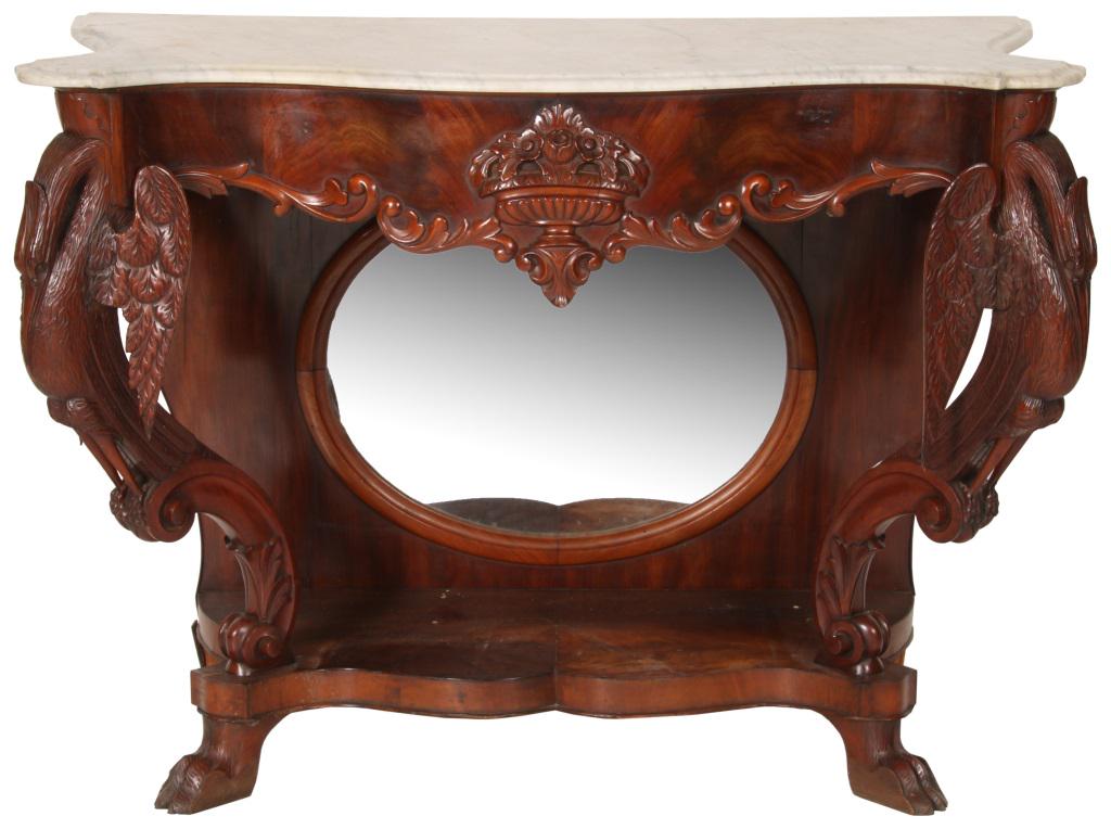 Swan Carved Mahogany Marble Top Console Table: Marble top mahogany console table has an inset oval mirror back with a central urn on the skirt with flowers. Full standing figural swans on each of the front legs. Dimensions: 38 in. high x 52 in. wi