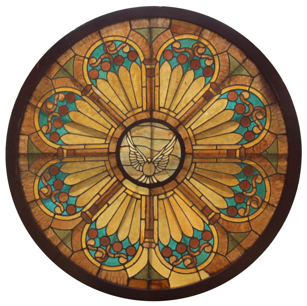 Round Leaded Glass Window with Dove: Round leaded glass window has a central dove being surrounded by ripple glass and colors of red, light and dark amber, and bright blue. Damage is as follows: 4 double line cracks, 1 hole, 8 single lin