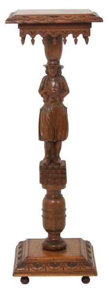 Figural Carved Oak Pedestal: Figural carved oak pedestal has a top with carved edge and fancy apron with teardrop acorn finials, turned post with figure of a colonial farmer holding a sickle and stands over a square base. Nice re