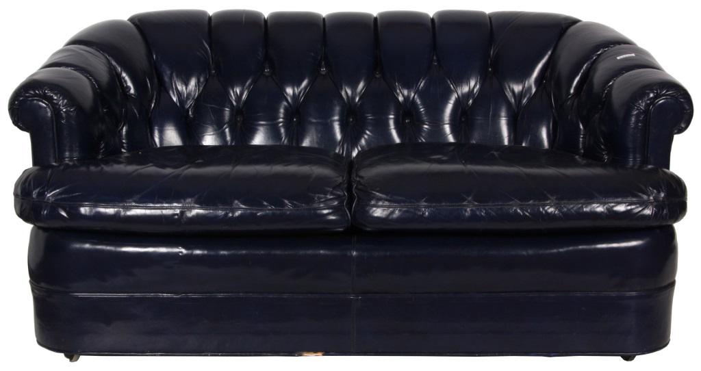 Blue Leather Settee: Blue Leather Settee. Padded curved back with tufted leather with general signs of use. Dimensions: 60 in. long x 34 in. wide x 31 in. high.