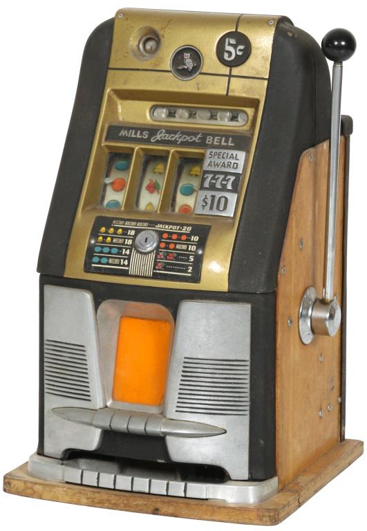 Mills "Jackpot Bell" 5 Cent Slot Machine: Mills Novelty Co. 5 cent tabletop slot machine has a decorative cast metal front with an owl motif at the top and reads: "Mills Jackpot Bell, Special Award, 7-7-7, $10." Dimensions: 26 in. high x 16 i